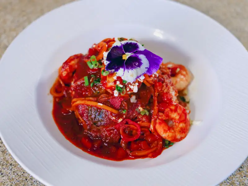 Rice topped with a chile relleno, shrimp and smothered in red sauce.