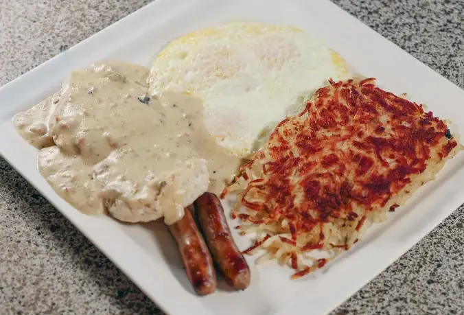 Biscuits covered in gravy served with sausage, eggs and hashbrowns.