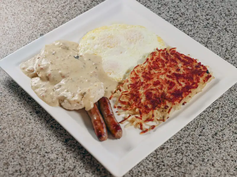 Biscuits covered in gravy served with sausage, eggs and hashbrowns.
