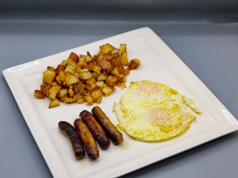 Two eggs served with country potatoes and sausage.