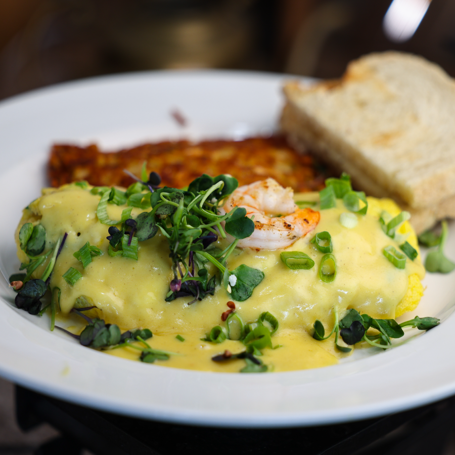 Alasakan Omelet topped with fresh spouts, shrimp and hollandaise served with hashbrowns and toast