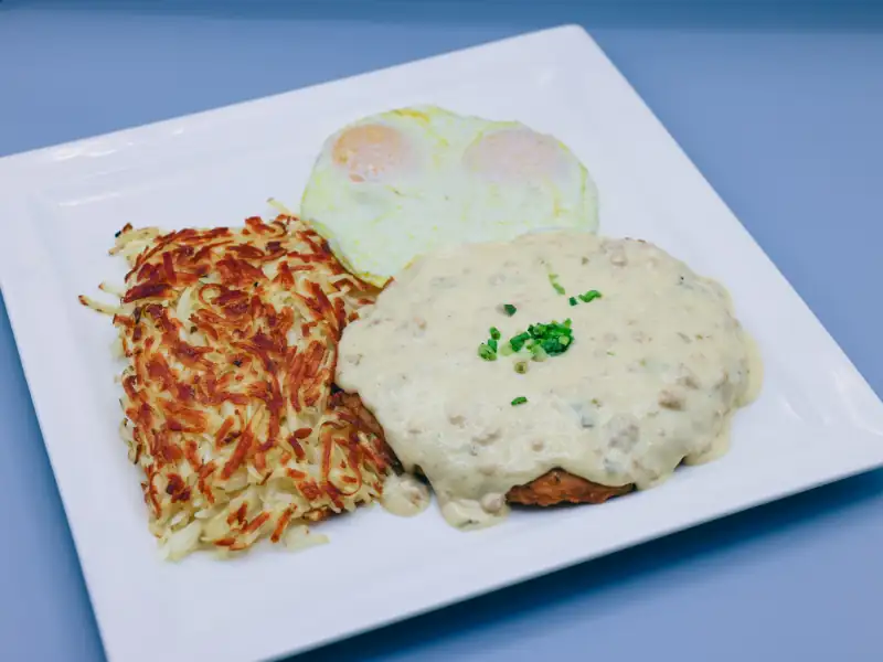 Chicken fried steak smothered in gravy and served with eggs and hashbrowns.
